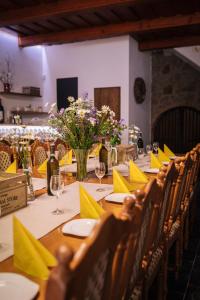 a dining table with yellow napkins and flowers on it at Vinný sklep André in Chvalovice