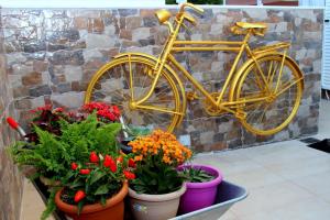 a yellow bike parked next to a bunch of flowers at Chania City Home in Chania