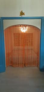a window with an orange curtain in a room at Ni La Za Ciccina in Castellammare del Golfo