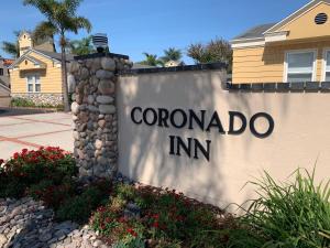 a sign for a coronado inn on a building at Coronado Inn in San Diego