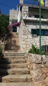 a stone staircase leading to a building with purple flowers at Apartments Vila Vino in Sveta Nedelja