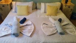 two stuffed animals are sitting on a bed at Apartments Vila Vino in Sveta Nedelja