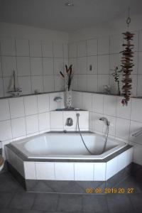 a bath tub with a faucet in a bathroom at Ferienhaus Harzvorland in Ballenstedt