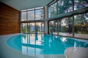 a swimming pool in a house with windows at Calfuco Wine Hotel & Spa in Villa La Angostura