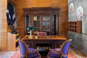a dining room with a wooden table and chairs at Calfuco Wine Hotel & Spa in Villa La Angostura