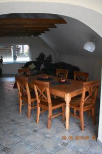 a wooden table and chairs in a living room at Ferienhaus Harzvorland in Ballenstedt