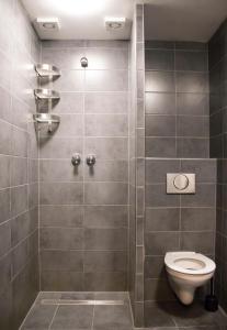 a bathroom with a toilet and a shower stall at Amsterdam Hostel Leidseplein in Amsterdam