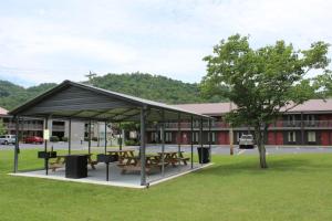 a picnic shelter in front of a building at Great Smokies Inn - Cherokee in Cherokee