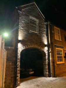 a brick building with a garage at night at The Lodgings in Beverley