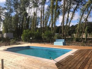 a swimming pool in a yard with trees at Pousio- Rural Appartments in Vagos