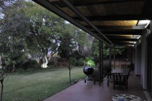 a patio with a table and a grill at Kestell Stables in Bloemfontein