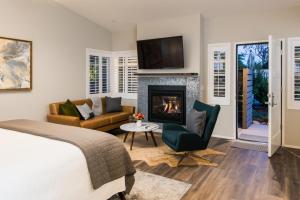 a bedroom with a bed and a fireplace at Olea Hotel in Glen Ellen