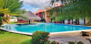 a swimming pool in front of a house at Condomínio Conchas e Corais in Barra Grande