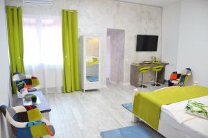 a room with a bed and a desk with a mirror at KAYA STUDIO in Sibiu