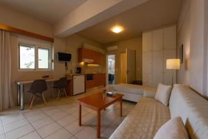 a living room with a couch and a table at Theoxenia Hotel Apartments in Chrani