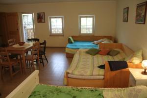 a bedroom with two beds and a table and a dining room at Rock&Lodge in Bohinj