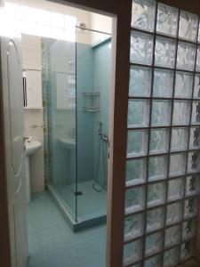 a bathroom with a glass shower and a sink at Dreamhome -10min from airport- in Artemida