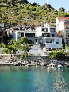 a house on the shore of a body of water at Katarina in Primošten