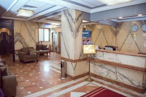 a lobby with a marble wall with a sign on it at Salma Hotel Cairo in Cairo