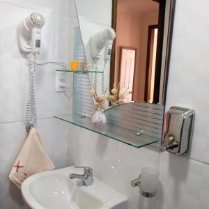 a bathroom with a sink and a mirror at Cabañas Cerro Zapata in Puerto Natales