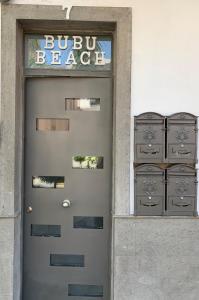 a door to a building with aubuc beagle sign on it at Bubu Beach 1-B in Los Cristianos