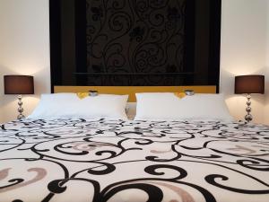 バート・メルゲントハイムにあるA&M Apartment Bad Mergentheimのベッドルーム1室(枕2つ、白黒のベッド1台付)