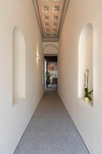 a hallway with white walls and a ceiling at Noma Hotel in Athens