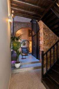 a hallway of a house with a plant in a pot at Noma Hotel in Athens