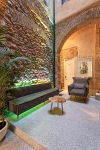 a room with a couch and a chair and a table at Noma Hotel in Athens