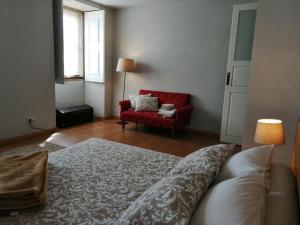 a living room with a couch and a red chair at Casa do Vale de Cerva in Cerva