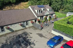 an overhead view of a house with a blue car parked in front at Auld Mill House Hotel in Dunfermline