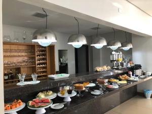 a buffet line with many different types of food at Bravo City Hotel Dourados in Dourados