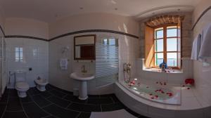 a bathroom with a toilet, sink, and bathtub at Heritage Boutique Hotel Adriatic-Adults only in Orebić