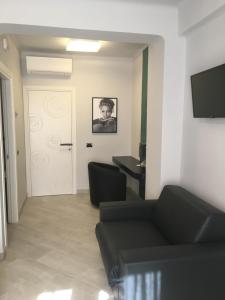 TV a/nebo společenská místnost v ubytování Le Divine di via Olivieri - Reception Via XXV Aprile 5