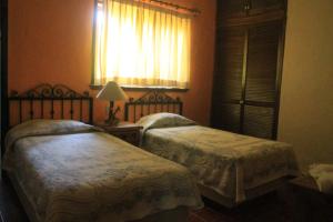 Postel nebo postele na pokoji v ubytování Quinta Comala Hotel & Villas