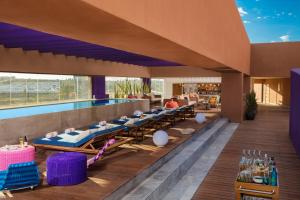 a resort with a swimming pool and lounge chairs at Hyatt Centric Campestre Leon in León