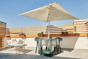 a table and an umbrella on a patio at CasaMeo in Marsala