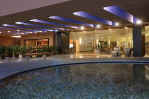 a lobby with a swimming pool in a building at Hyatt Centric Campestre Leon in León