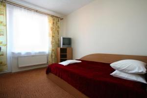 Postel nebo postele na pokoji v ubytování Hotel Dobele + 29 fotografií