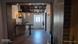 a hallway of a kitchen with a table and a door at Casa O Chaparrinho in Monsaraz