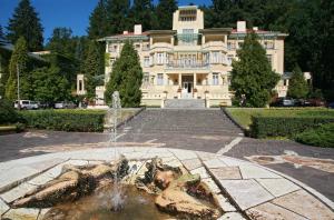 a large house with a fountain in front of it at Dům Bedřicha Smetany in Luhačovice