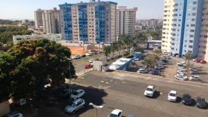 a parking lot with parked cars in a city at Golden Dolphin Express Roberto imoveis in Caldas Novas