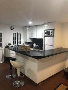 a kitchen with a black counter top in a room at Casa das Catrinas in Ponte da Barca