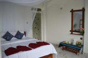 a bedroom with a bed and a table with a mirror at Heavens Seven in Ella