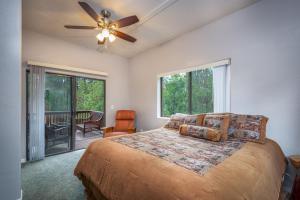 a bedroom with a bed and a ceiling fan at Pinetop Paradise in Pinetop-Lakeside
