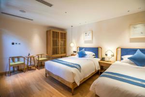 Letto o letti in una camera di Beijing Heyuan Courtyard Hotel (Forbidden City)