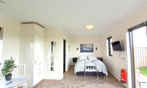 a bedroom with a bed and a desk in it at Austurey Cottages in Laugarvatn