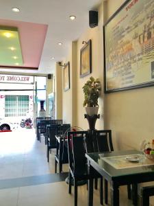a dining room with tables and chairs in a restaurant at Canary Hotel Hue in Hue