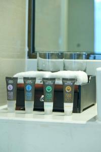 a row of four hair products on a counter at Novotel Guiyang Panjiang in Guiyang