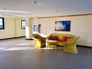 a living room with a couch and chairs and a table at La Primera Grande Beach Resort in Roxas